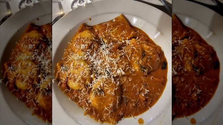 bowl of lobster ravioli topped with grated cheese