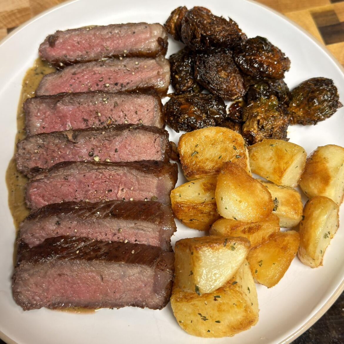 [homemade] NY strip with roast potatoes and maple sriracha Brussels sprouts