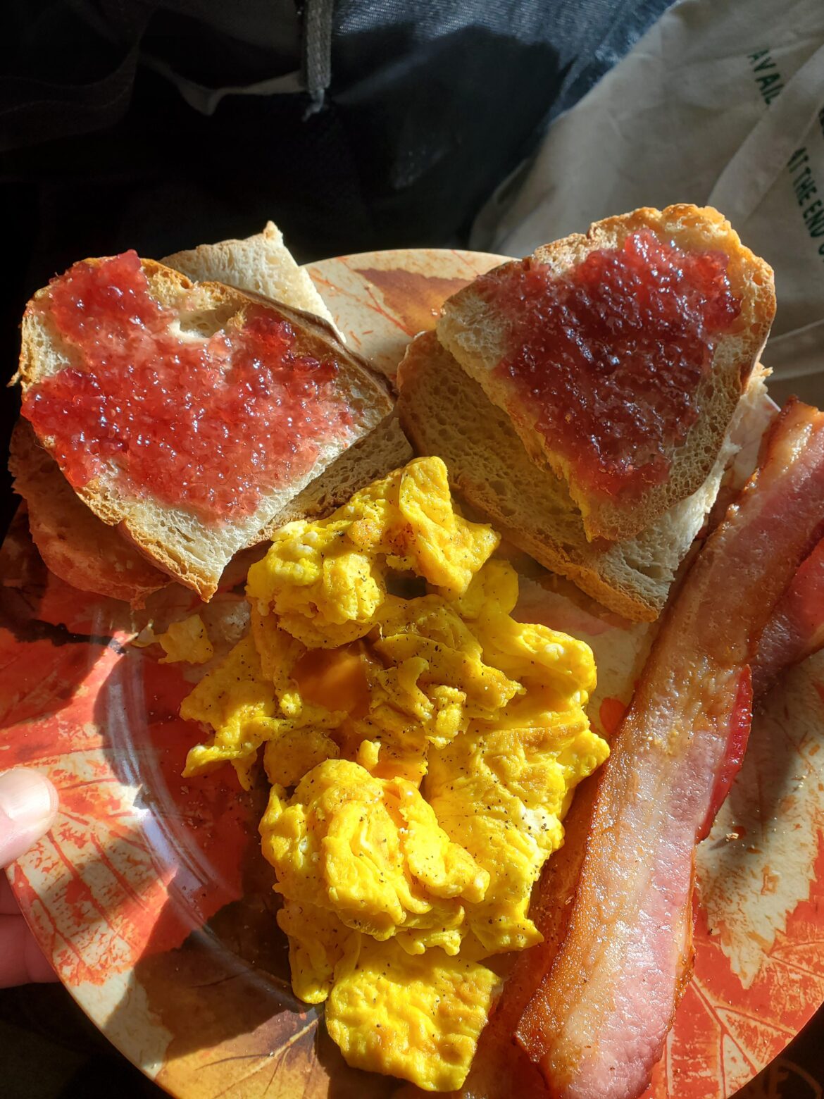 Scrambled eggs, toast with jam, & bacon