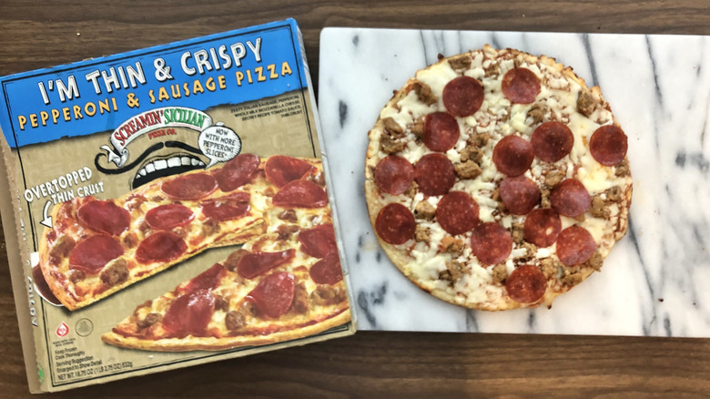 Screamin' Sicilian Thin & Crispy pepperoni and sausage pizza on cutting board.