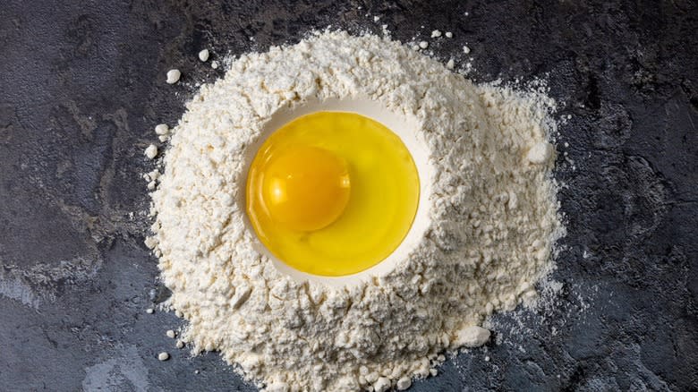 egg in a flour well for pasta-making