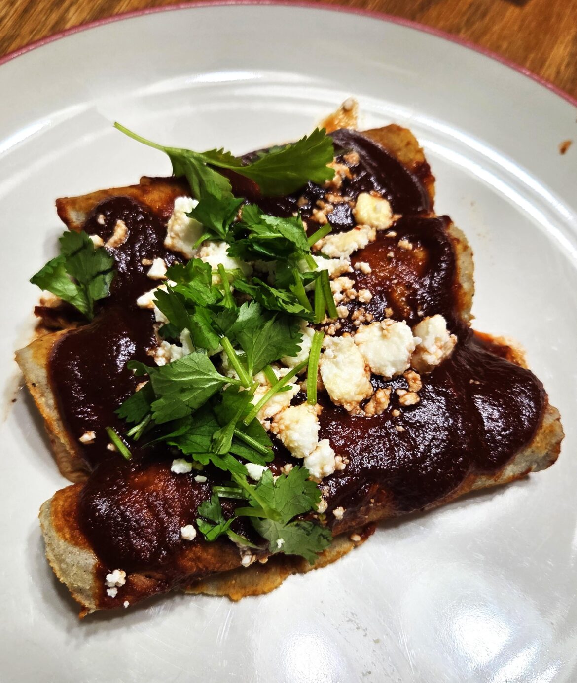 Chicken and Green Chili Enchiladas with a red chili sauce