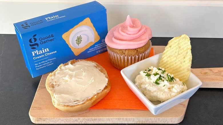 Good & Gather cream cheese on a wooden cutting board with bagel, cupcake and chip dip