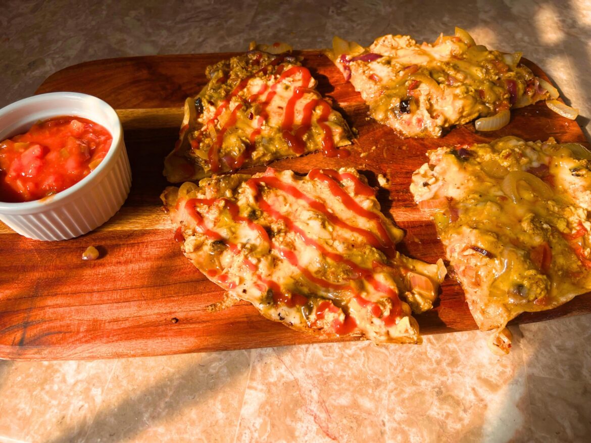 Cheesy loaded breakfast quesadillas drizzled with hot sauce, and a side of fresh salsa