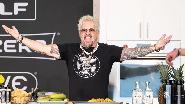 Guy Fieri cooking on a stage