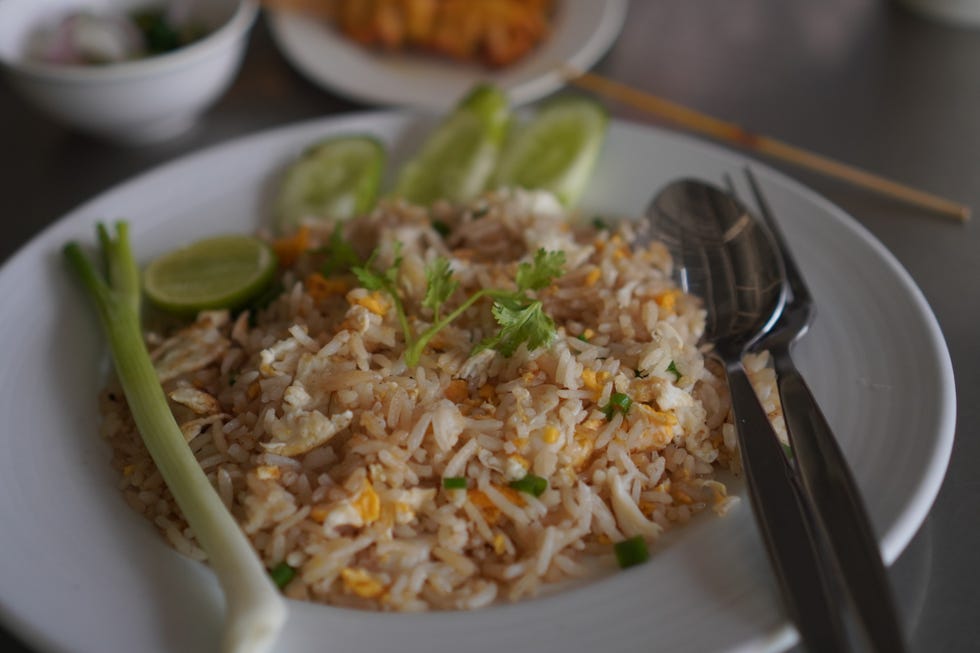 Crab meat fried rice topped with Scrambled egg, style Thai food in white plate read to eat