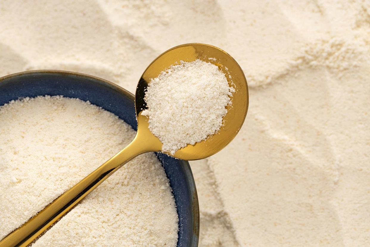 hydrolyzed collagen powder in bowl and spoon - Organic gelatin powder.