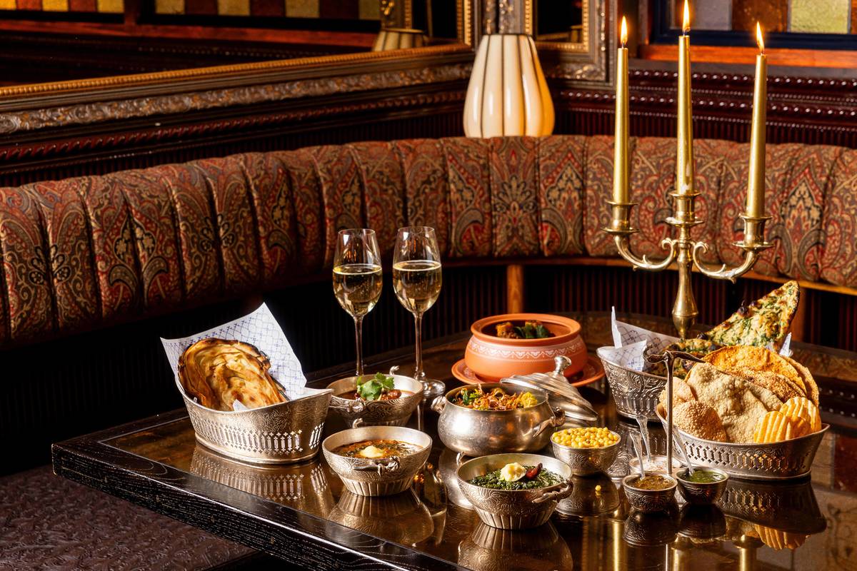 a table at ambassadorts clubhouse set with a festive diwali array of food
