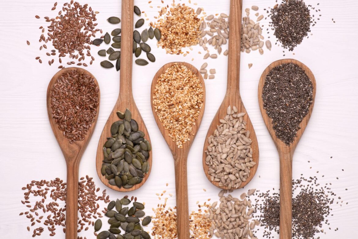 Legacy Project to support National Food Bank ahead of World Seed Congress 2026 Healthy seeds - sesame, flax seed, sunflower seeds, pumpkin seed, chia in wooden spoons on a white background. Top view