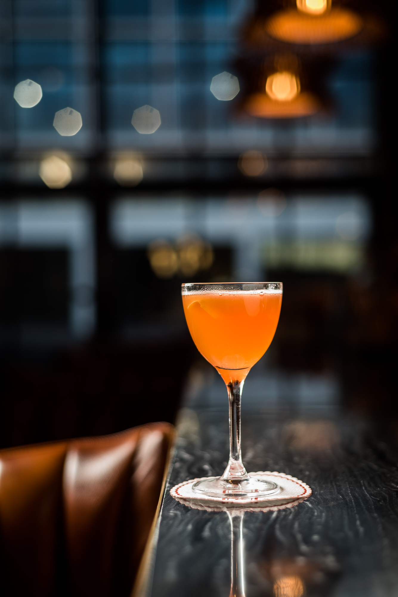 A paper plane cocktail contains lemon, aperol, bourbon, and amaro.