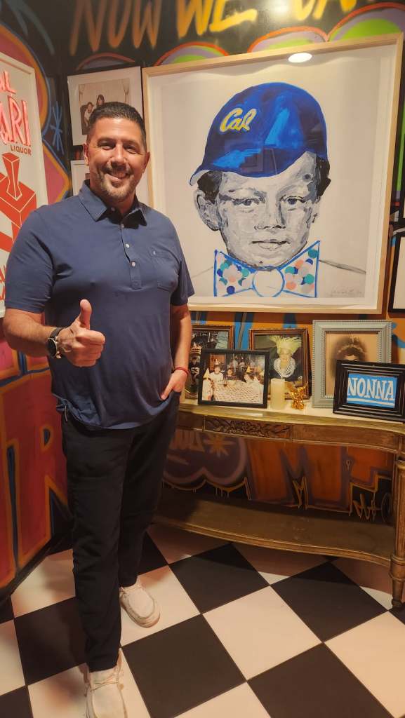 Chef Joe Isidori in front of the photo homage to his family, generations of restaurateurs in New York. (Photo: Jan Norris/Stet)