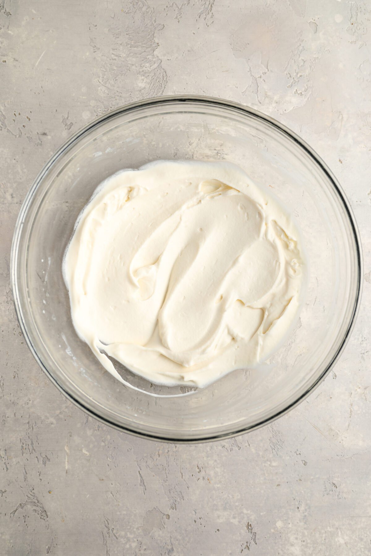 glass bowl with whipped cream beaten to medium peaks
