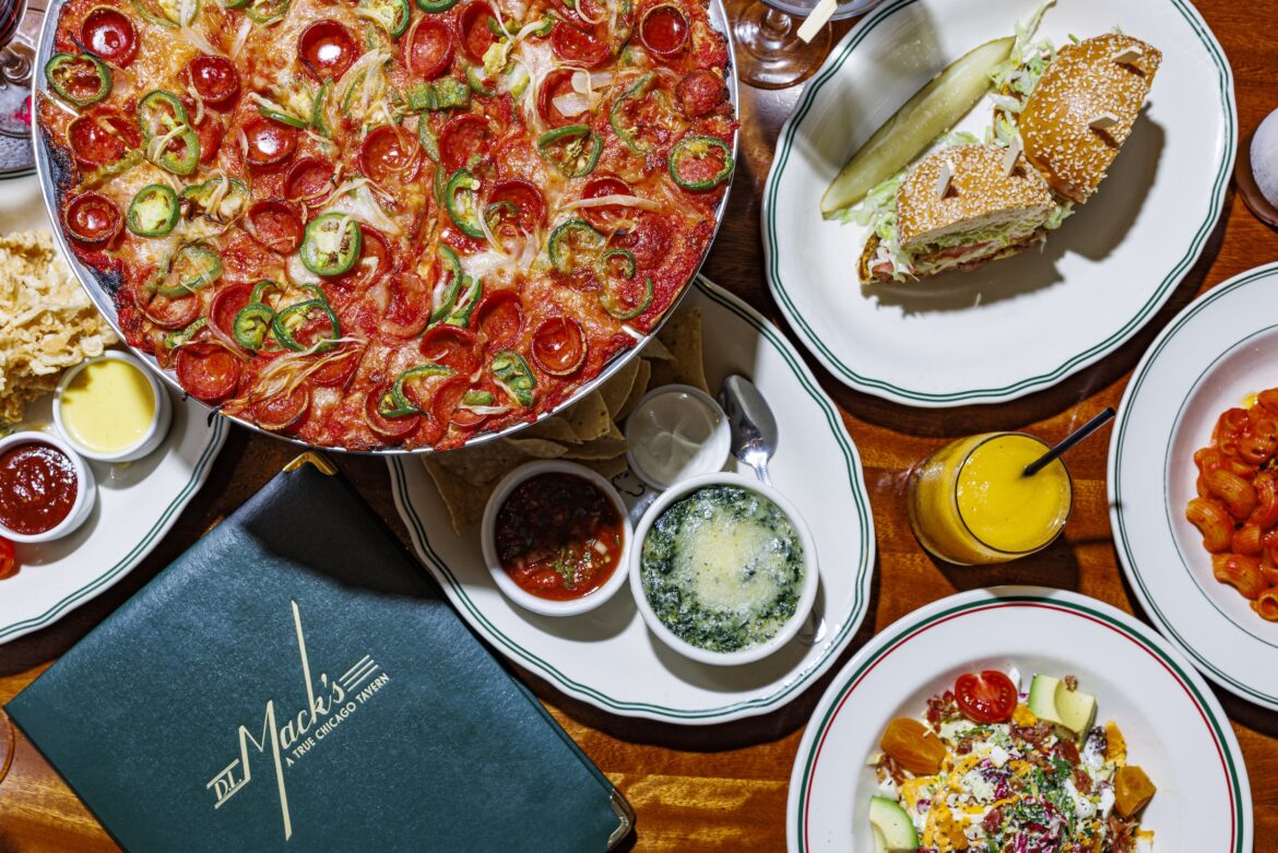 A table at DL Mack's full of some of their signature men items including a sandwich and pizza.