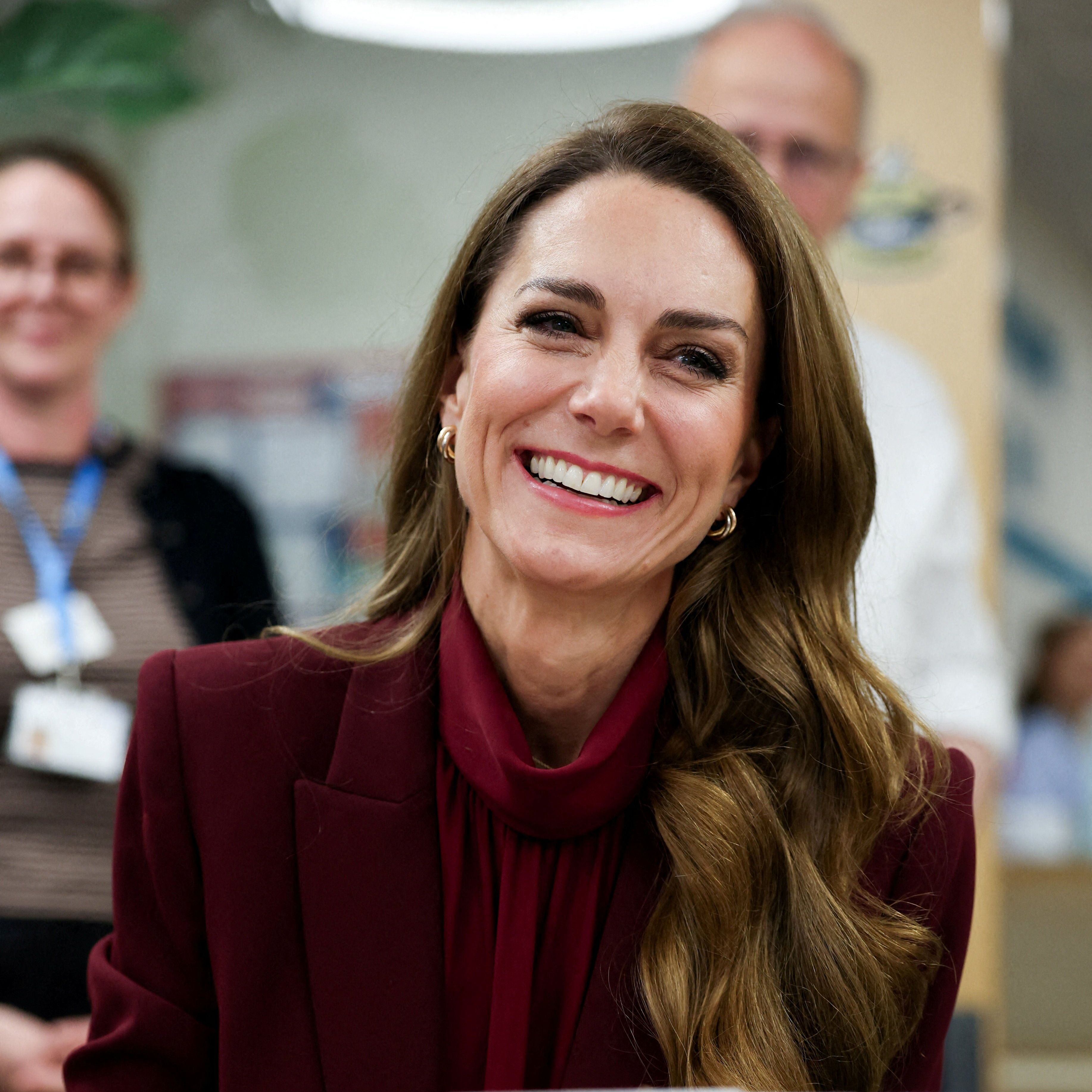 Princess Kate wears a red silk blouse and jacket