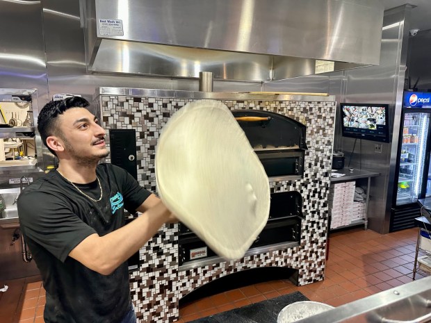 Pasquale LoDuca, the new owner of LoDuca's Italian Restaurant in Cressona, prepares a pizza. (MICHAEL URBAN/STAFF PHOTO)