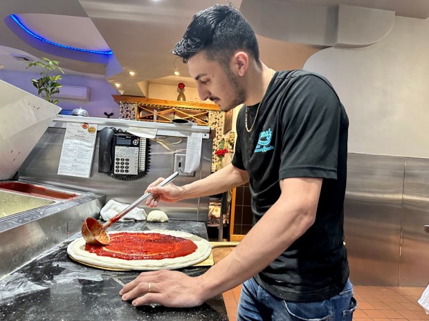 Pasquale LoDuca, the new owner of LoDuca's Italian Restaurant in Cressona, makes a pizza. (MICHAEL URBAN/STAFF PHOTO)