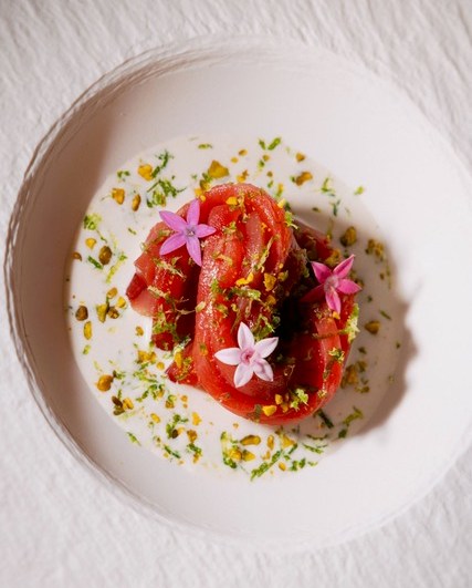 an overhead shot of the akami spaghettoni at kinjo in tampa. it features long slices of tuna with a bagna cauda cream sauce.