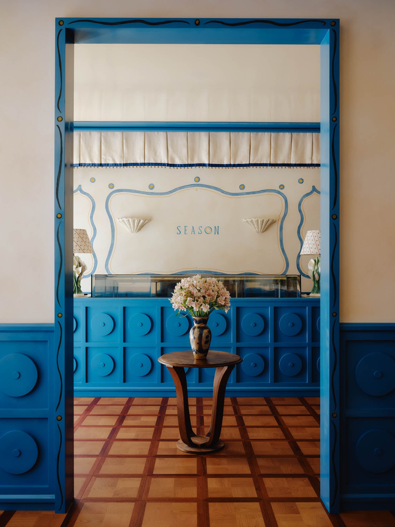 view of the entryway with beautiful wood table and blue accents