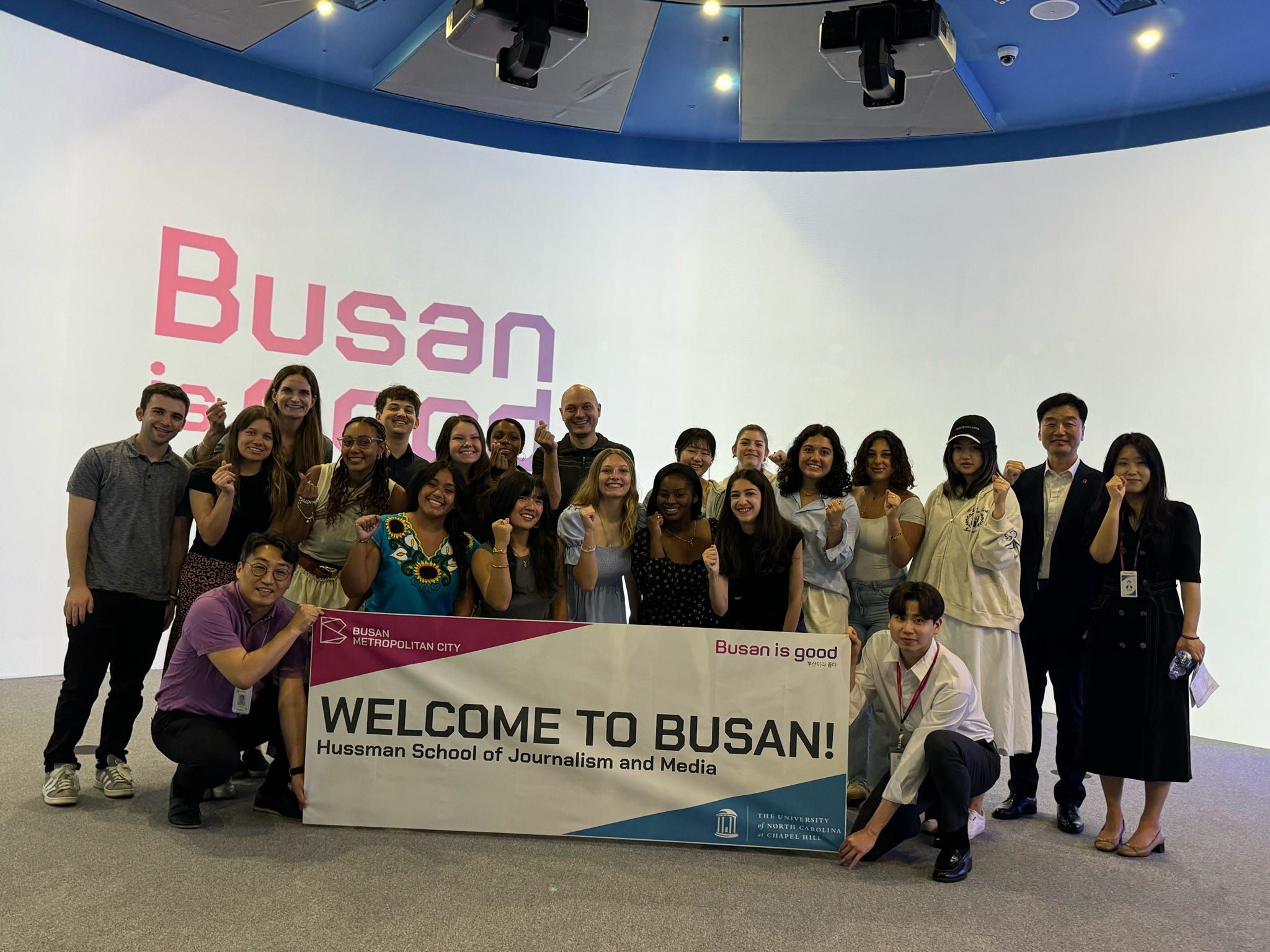 Students in the MEJO 437: Media and Culture class pose with a banner in South Korea.