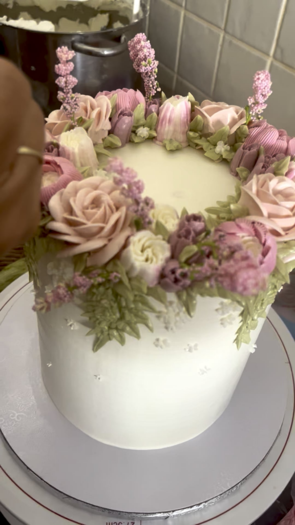 A close up of the final tiny details that go into a floral cake
