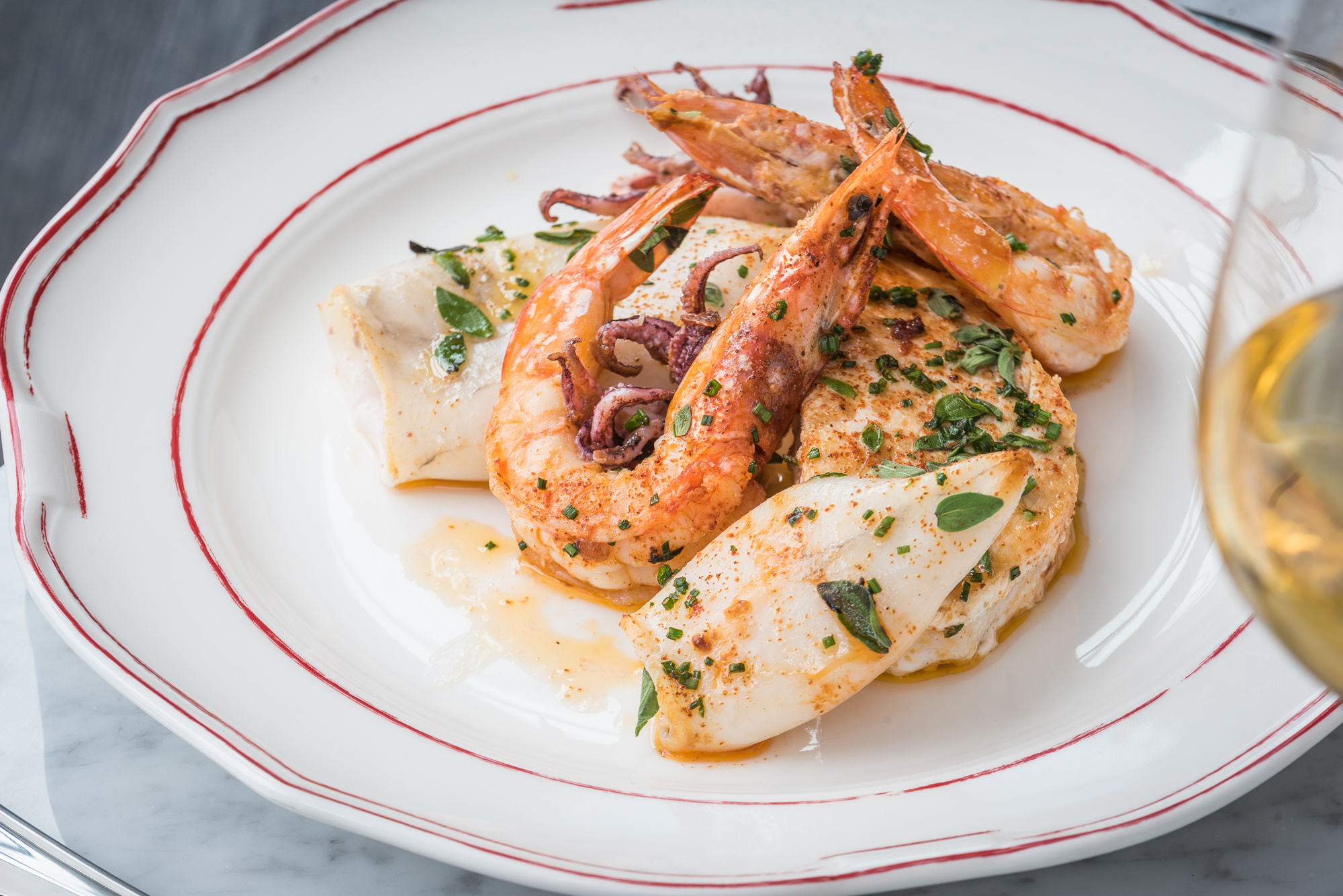 The mixed seafood grill contains swordfish, calamari and prawns.