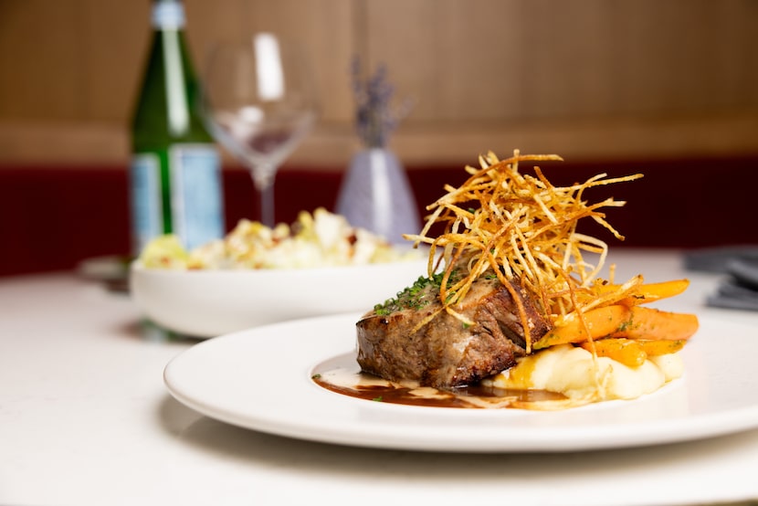 The 8 oz. filet mignon, served with roasted carrots, horseradish mash and au poivre, at...