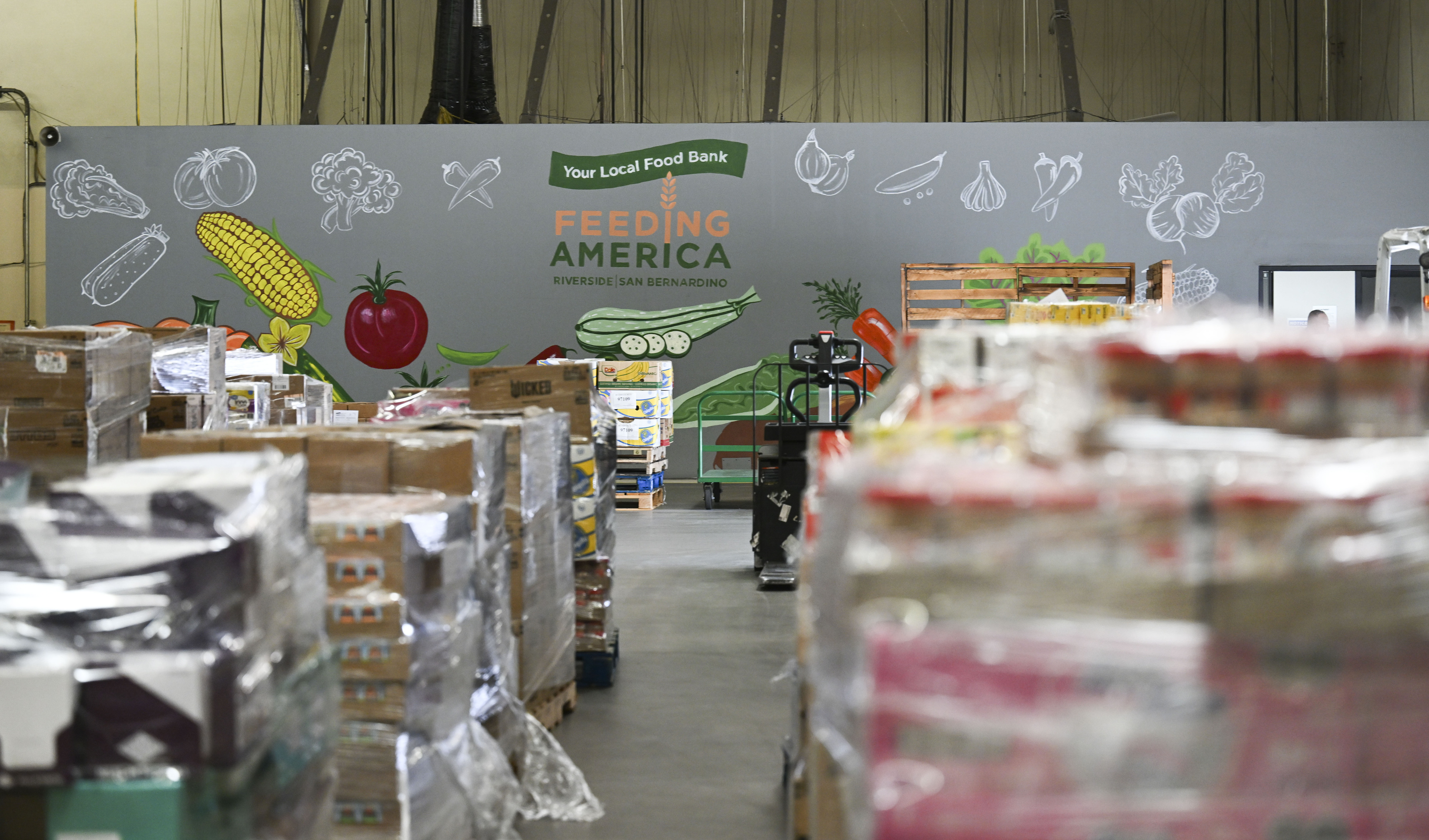 Pallets of dry goods are stacked for distribution Wednesday, March...