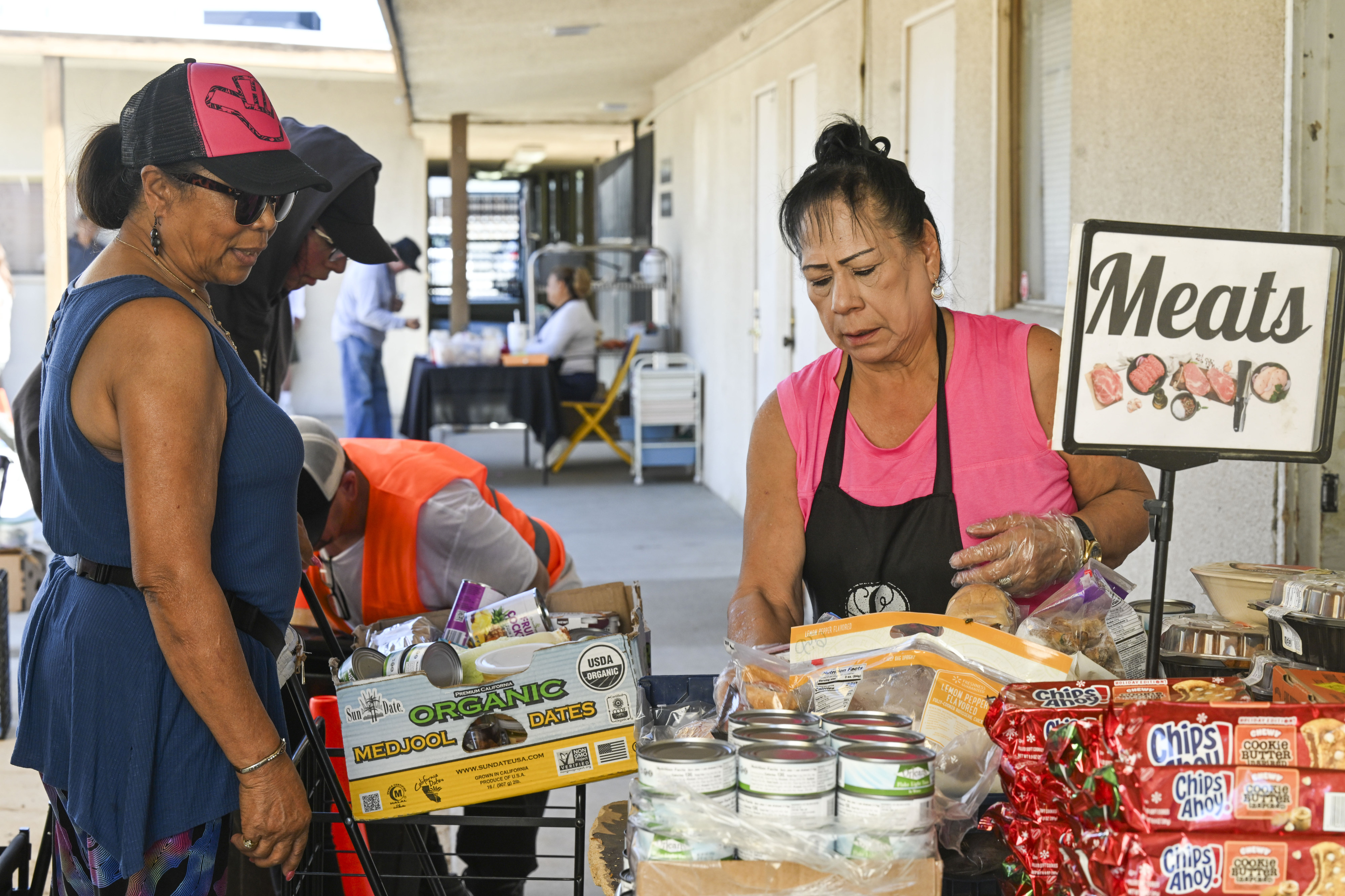 Riverside residents receive fresh food, including meat, at the Lighthouse...