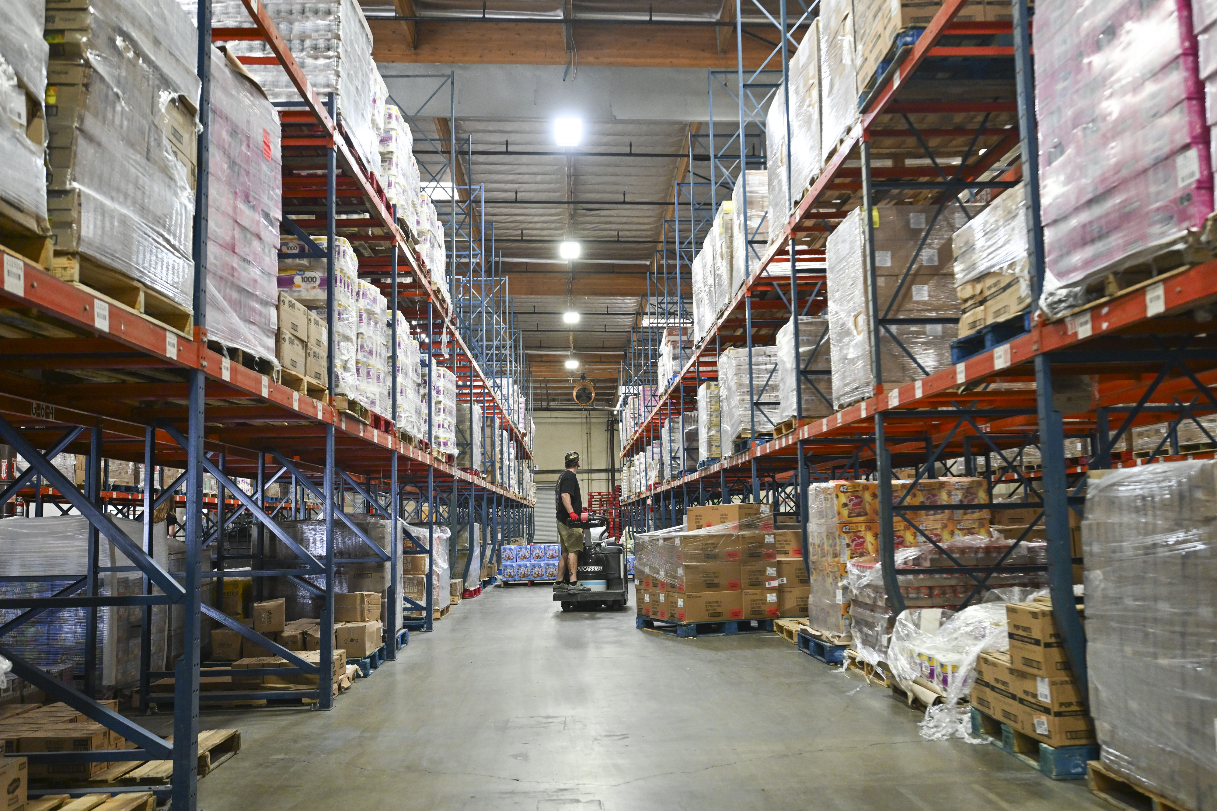 Pallets of dry goods are organized for distribution at the...