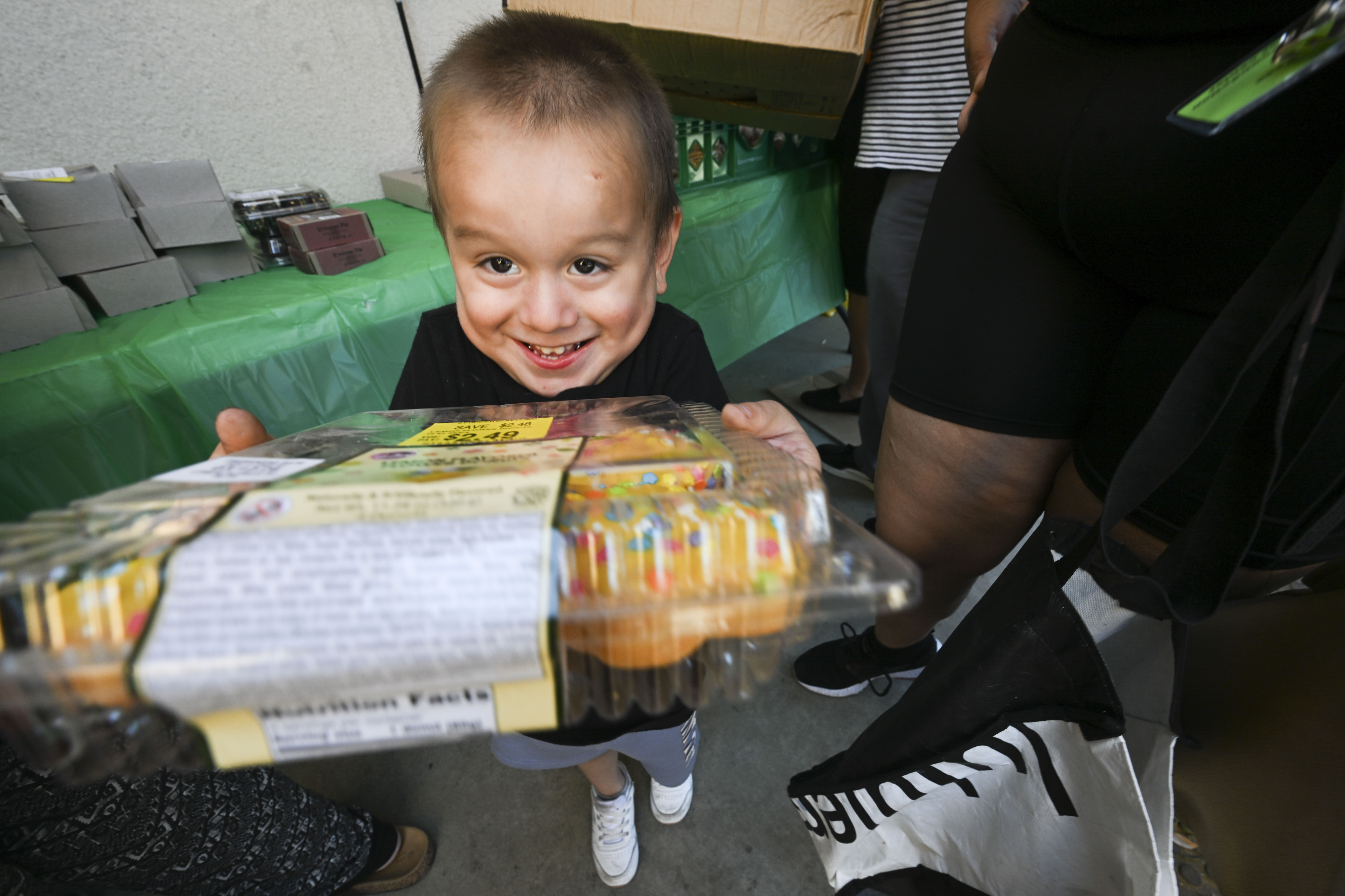 Jesus Cruz holds a box of muffins he and his...