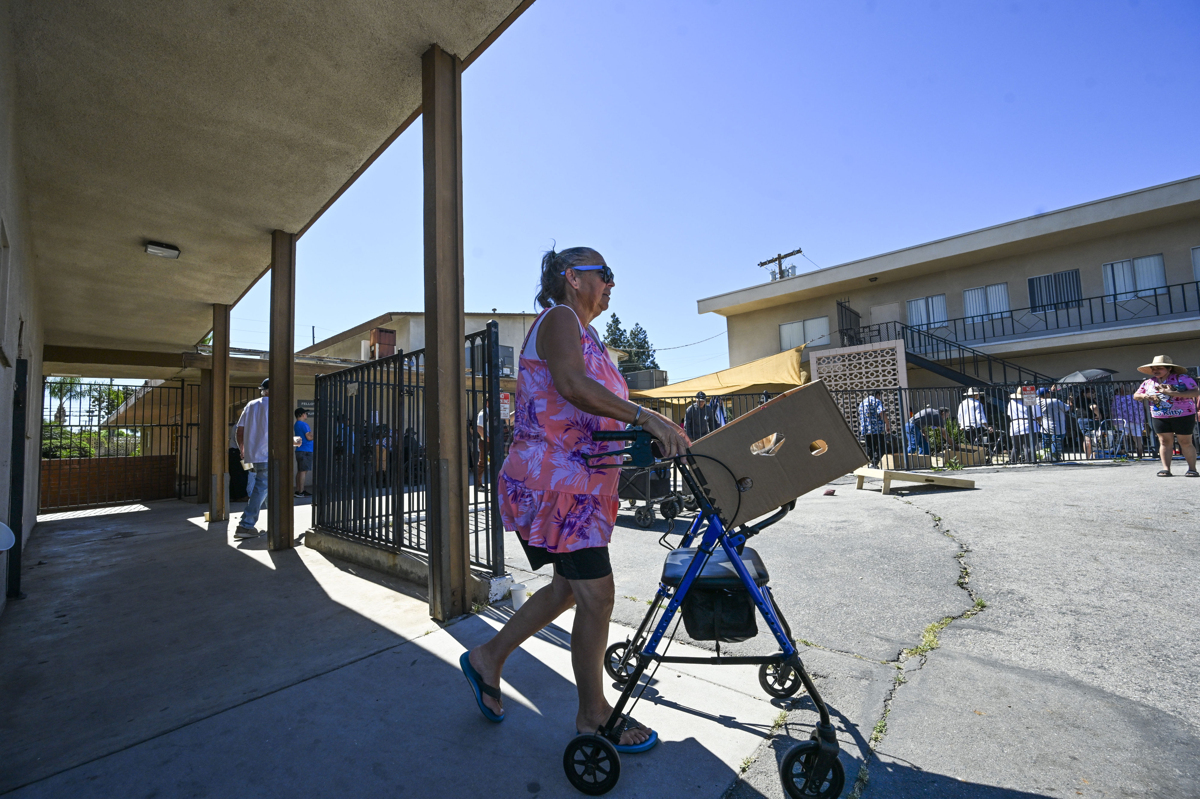 Riverside residents leave the Lighthouse of Hope food pantry in...