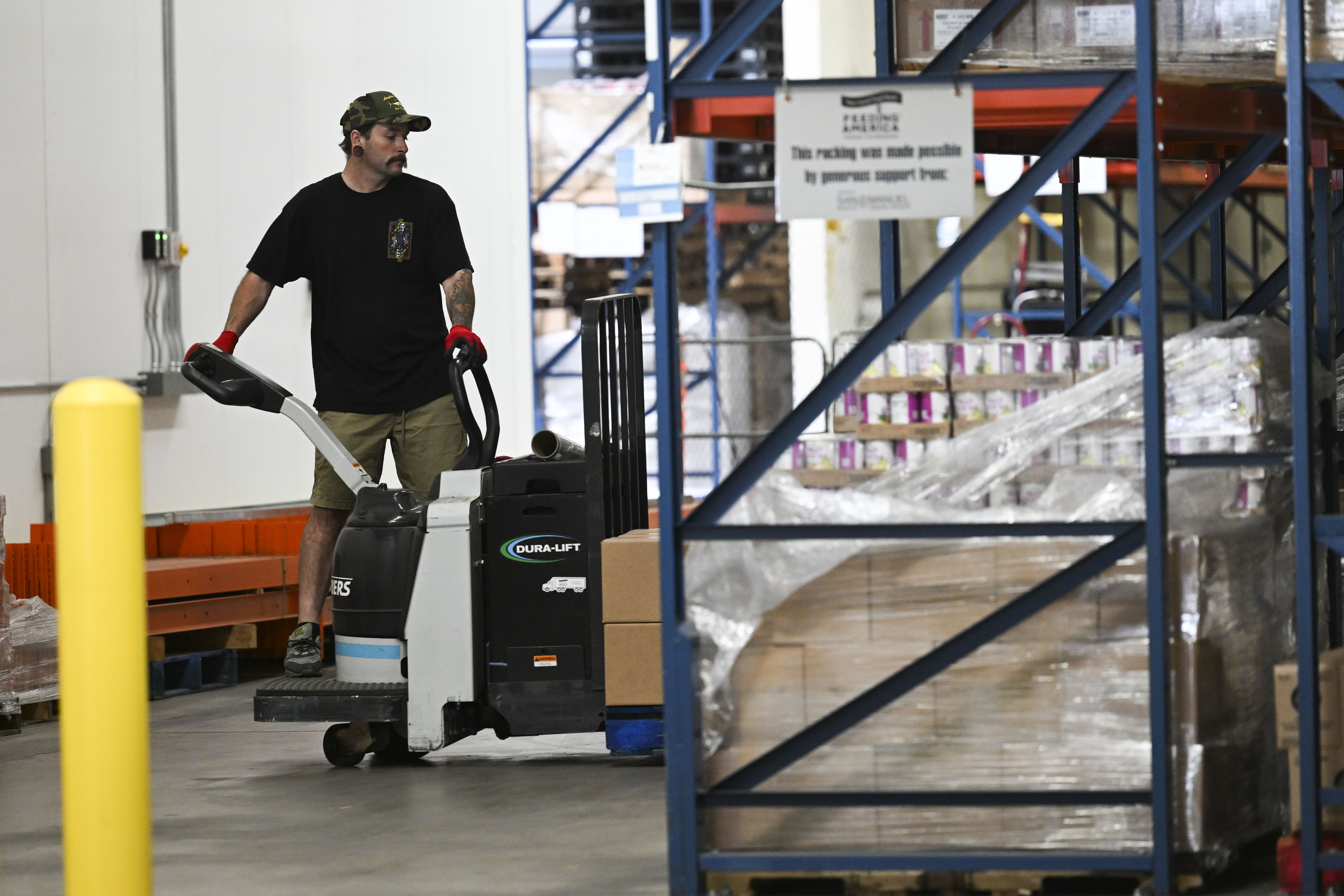 Pallets of food are organized by Brandon Curtis on Wednesday,...