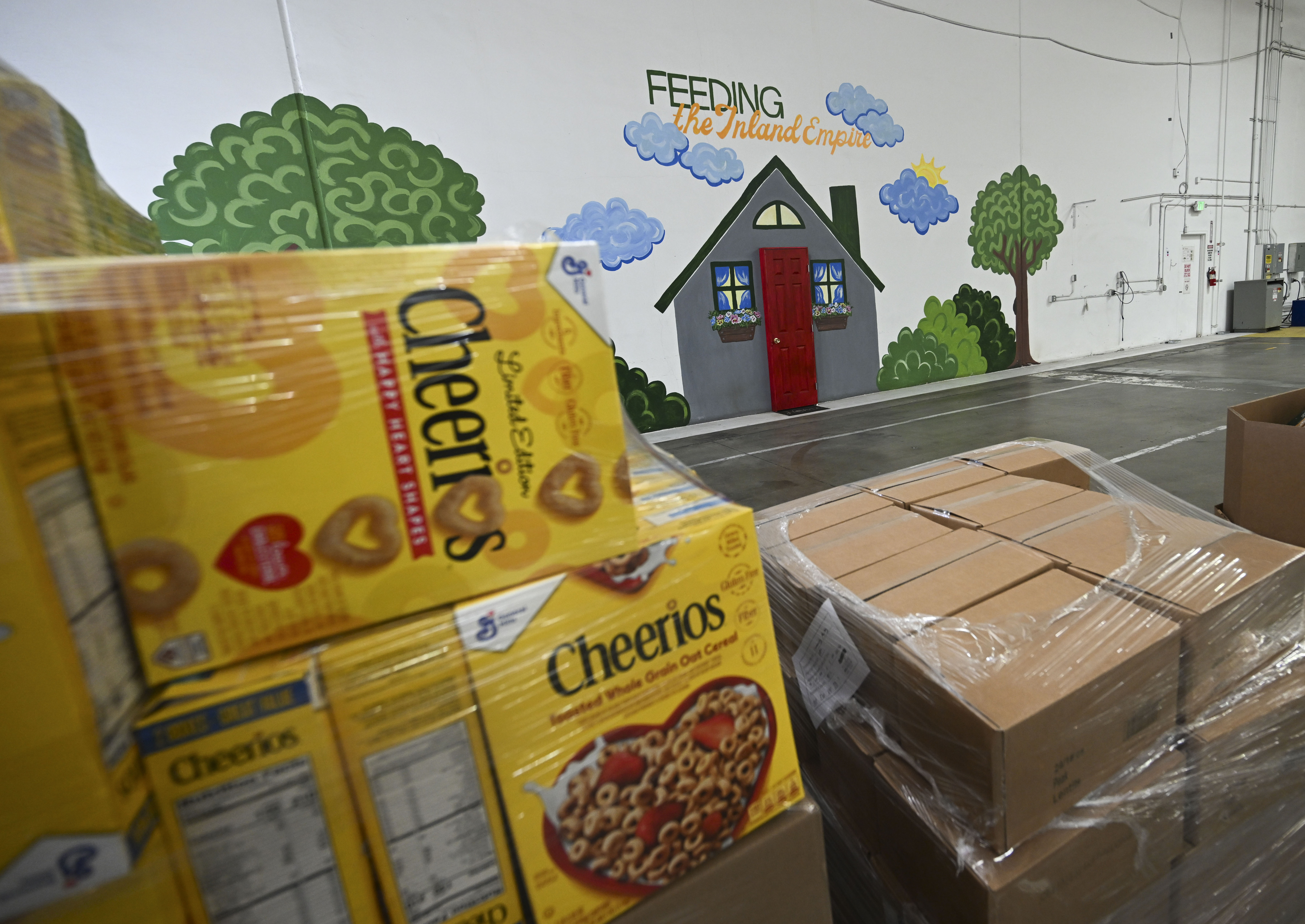 Pallets of dry goods are stacked for distribution Wednesday, March...