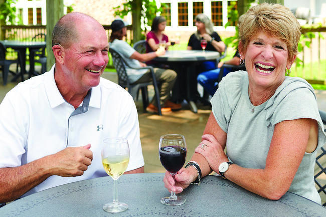 couple sitting on outdoor patio drinking wine at Raven's Glenn Winery in West Lafayette, Ohio