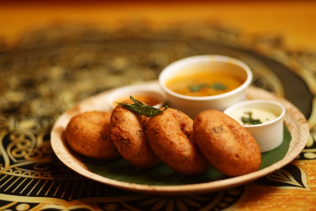 Medhu Vadai, or doughnut-shaped fritters made from lentil flour, are served on a banana leaf at Mylapore restaurant in San Jose on Monday, Feb. 23 2026. (Aric Crabb/Bay Area News Group)