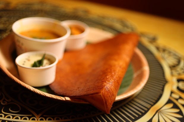 A Benne Dosa, aka a dosa cooked in butter, is served at San Jose's Mylapore restaurant on Monday, Feb. 23 2026. Sambar, the spicy stew that accompanies a dosa, varies from region to region in South India. (Aric Crabb/Bay Area News Group)