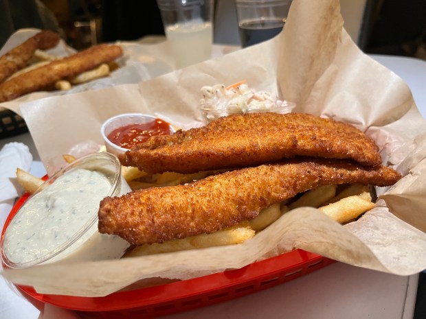 Fish, fries, coleslaw and tartar sauce in a basket