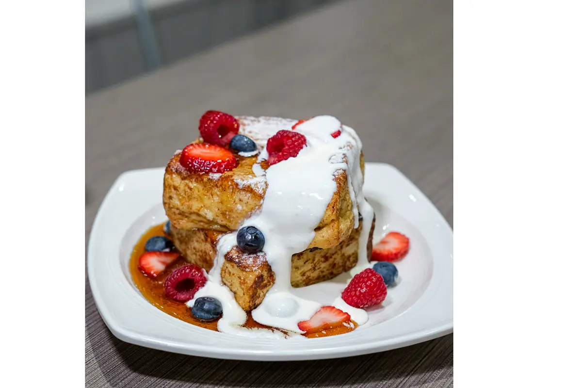 whipped cream and fruit on top of a pastry at Shilla Bakery