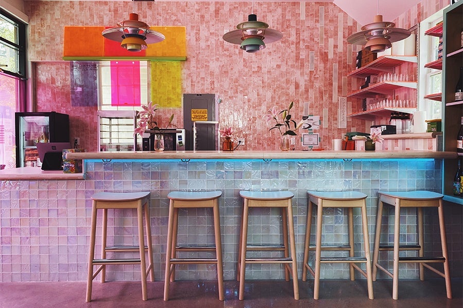 A well-lit bar features shimmery pink walls and a well-lit ambiance.