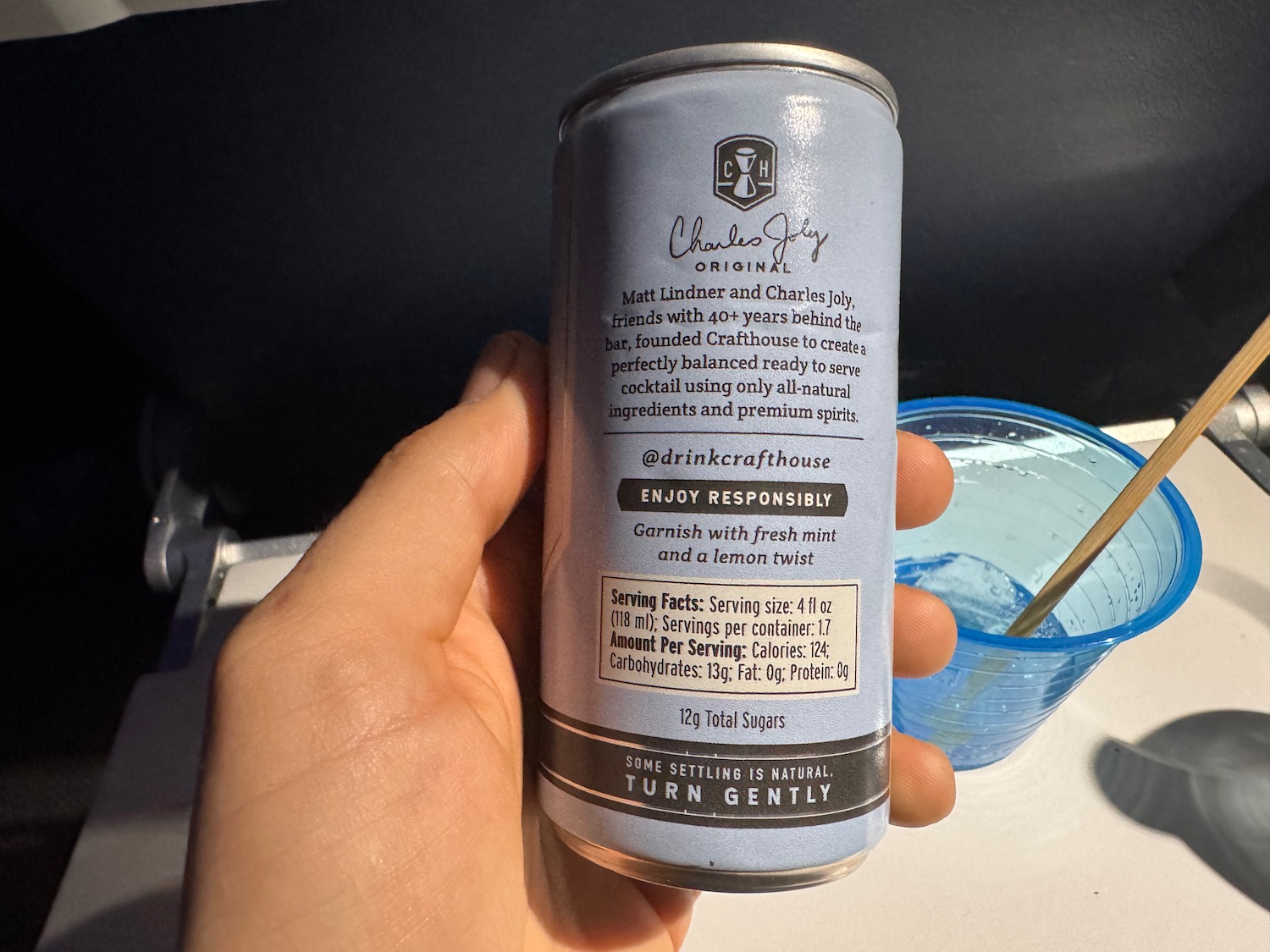 a hand holding a can of beverage