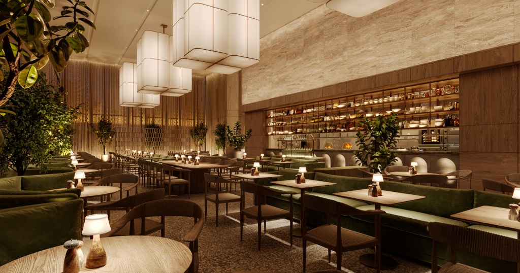 Modern restaurant featuring green velvet banquettes, wooden tables, and woven chairs with warm lighting from rectangular pendant lights hung above.