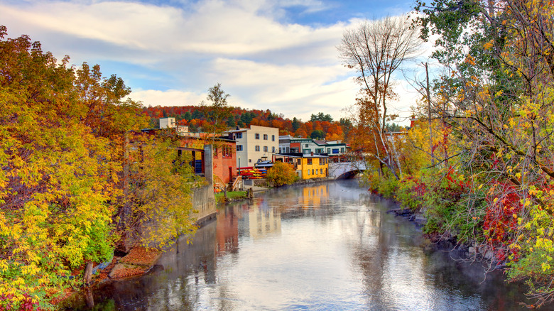colorful buildings along Saranac Lake waterfront canal with fall foliage