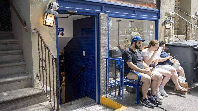 People enjoying cookies outside of Levain Bakery in NYC's Upper West Side
