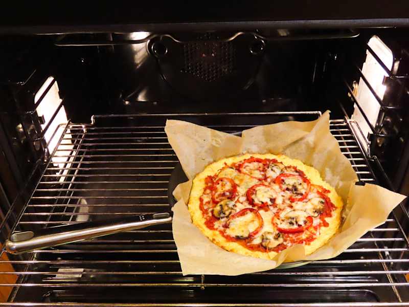 Pizza cooking in oven.