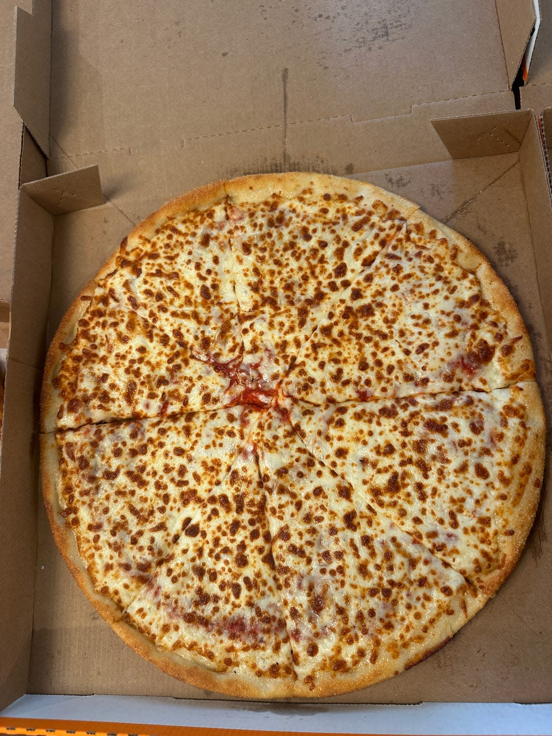 cheese pizza in a cardboard box with visible slices