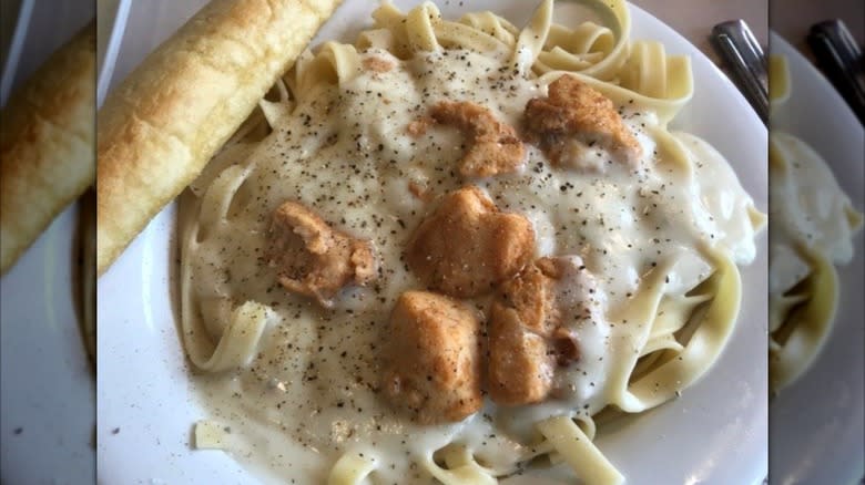 Fazoli's Chicken Alfredo, on a plate, with a breadstick