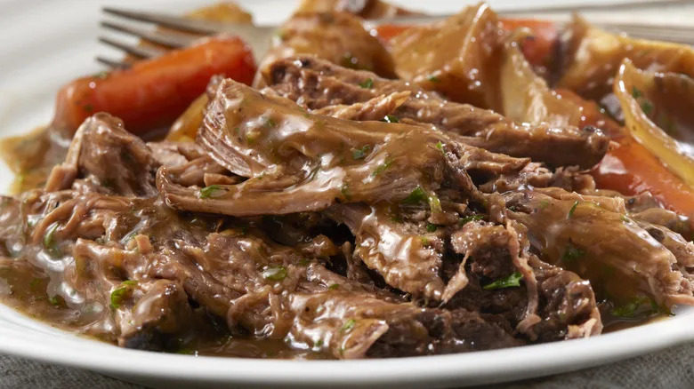 Pot roast is served up on a white platter