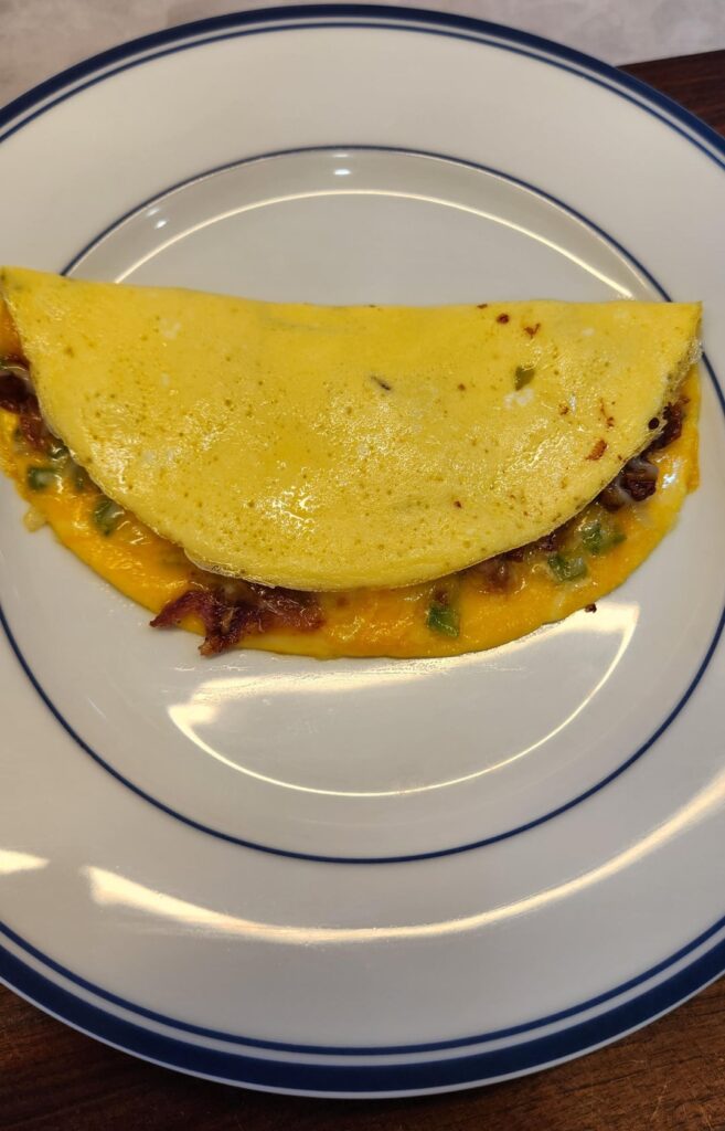 Omelet with peppers, onions, cheese and crumbled bacon
