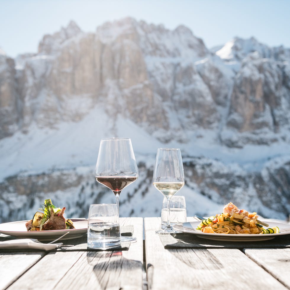 dining set with food and drinks against a snowy mountain backdrop dining set with food and drinks against a snowy mountain backdrop