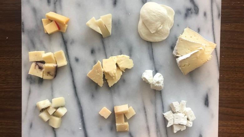 10 different kinds of Kirkland cheeses on a cheese board.